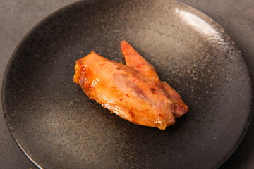 Grilled chicken wings cooled overnight on a black plate