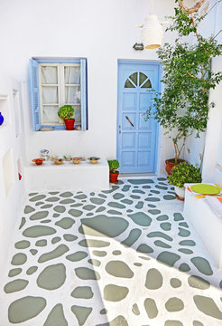traditional yard at Ano Koufonisi island Cyclades Greece with turquoise wooden door and window 