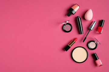 Set of decorative cosmetics on pink background. Flat lay, top view, copy space. Beauty and fashion concept.
