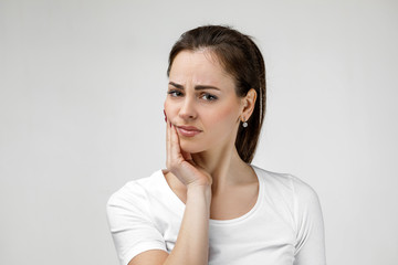 young sad woman suffering from tooth pain, caries. girl having toothache. Dental health and care...