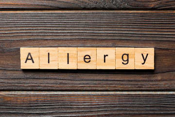 Allergy word written on wood block. Allergy text on wooden table for your desing, concept