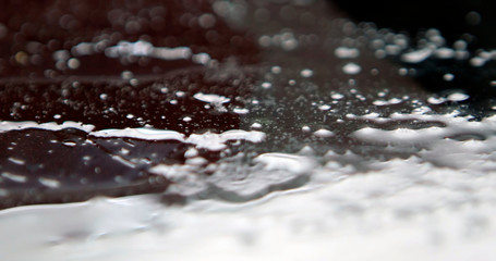 On a black background, frozen shot of water splashing