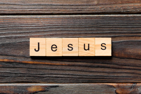 Jesus word written on wood block. Jesus text on table, concept