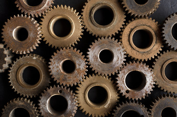 Closeup of lot of gears as a background.Broze and silver color gears