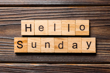 hello sunday word written on wood block. hello sunday text on wooden table for your desing, concept