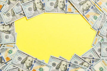 Frame of one hundred dollar bills with empty space for your design. Top view of business concept on...