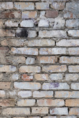 Old and traditionally masonry wall made of cement and bricks in various colors and shades.