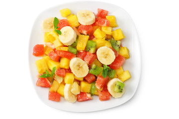 Bowl of healthy citrus fruit salad isolated on white background. Top view.