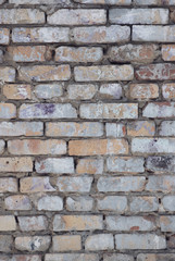 Old and traditionally masonry wall made of cement and bricks in various colors and shades.