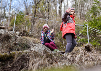Children hiking in the mountains or woods on family trip.