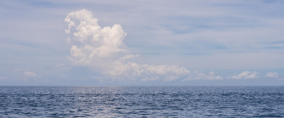 Clear blue seascape with white cloudy