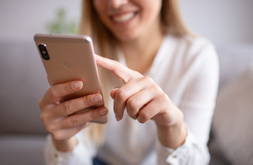 Smiling young woman with mobile. Surfing the internet concept,social media. Young woman using her smart phone