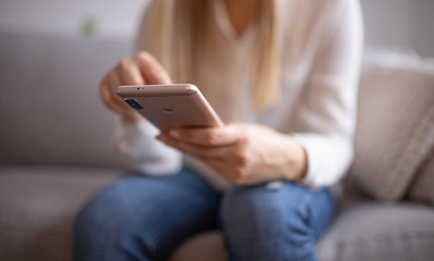 Smiling young woman with mobile. Surfing the internet concept,social media. Young woman using her...