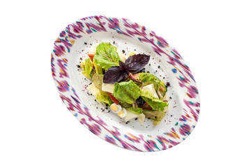 Fresh vegetable mix salad with egg and basil isolated on white background