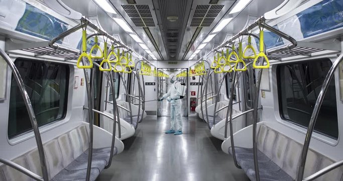 HazMat team in protective suits decontaminating metro car during virus outbreak. 50 FPS Slow motion