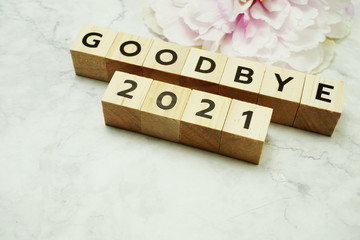 Goodbye 2021 alphabet letters on marble background