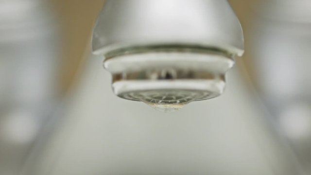Dripping water from faucet in bathroom, 4k