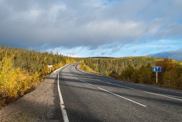 Fototapeta na wymiar Northern country road among hills