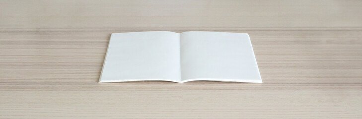 Mock up blank open paper book on wood table background
