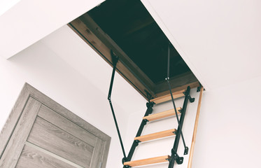 Wooden staircase to the attic in the house © SkyLine