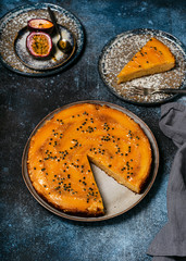 Homemade mango upside down cake with passion fruit and a piece cut off on a plate. Summer tropical dessert. Selective focus.