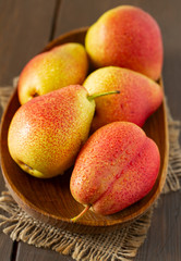 beautiful ripe pears on wooden surface