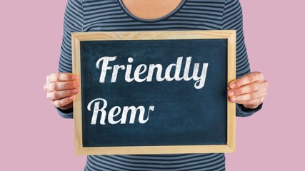 Woman holding small blackboard with animated text Friendly Reminder