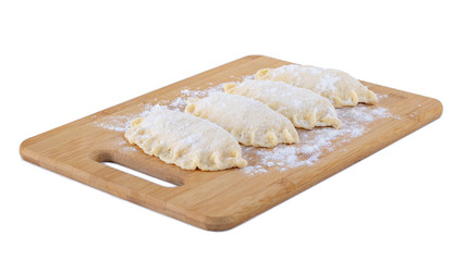 Raw dumpling with cheese. Preparation dumplings on a wooden board