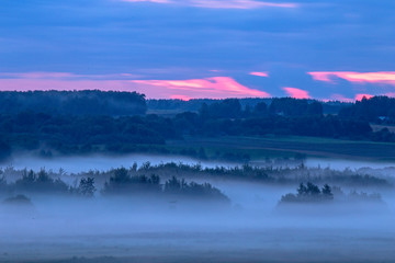 Evening fog over the fields. Agricultural landscape in eastern Lithuania.