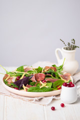 fresh salad of ham, lettuce and cheese with cranberries on a plate