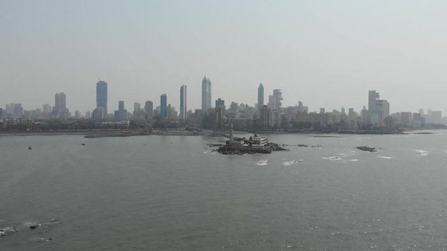 Rotating drone shot of Haji Ali dargah sea mosque with Mumbai city in the background