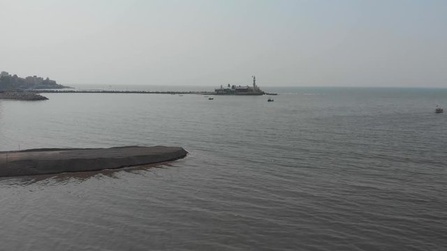 Drone shot of Haji Ali Dargah with small fishing boats in the foreground