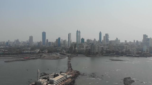 Overhead drone shot of Haji Ali dargah sea mosque with the Mumbai skyline in the background