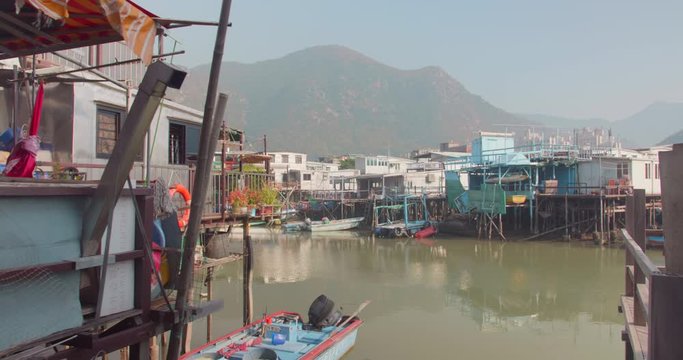 Tai O fishing village & its beautiful houses on stilts (Lantau island, Hong Kong, China). Sunny outdoor peaceful atmosphere. Trackin in dolly shot. The quaint Venice of Asia.