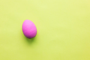 Blue Easter egg on a pink background.