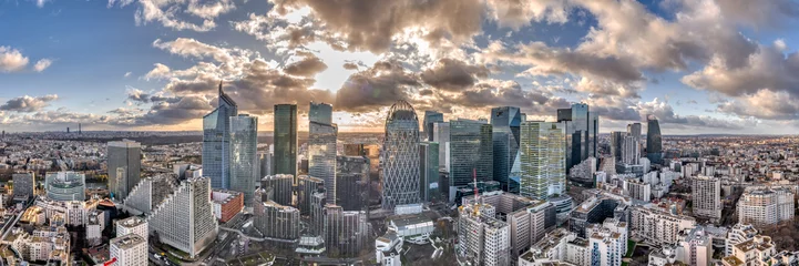 Foto op Canvas Aerial panoramic drone shot of La defense skyscraper in Paris with clouds and sunset © Davidzfr