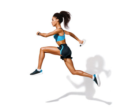 Young fitness girl running with bottle of water. Photo of african american girl in fashionable sportswear on white background. Dynamic movement. Side view. Full length. Sports and healthy lifestyle