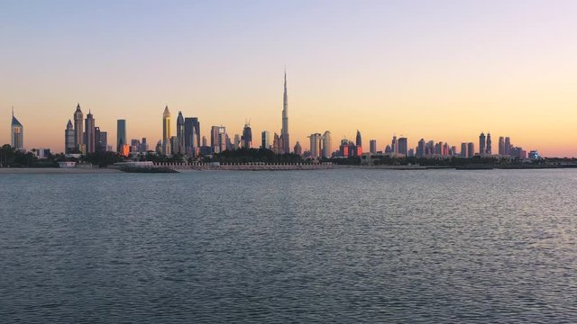 City skyline view from the lake in Dubai, UAE during sunset