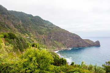 Fototapeta na wymiar Dramatic coastal scenery of the village of Boaventura and the Arco de Sao Jorge mountain range on the north coast of the Portuguese Island of Madeira