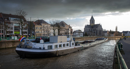 Barge at river Schelde Belgium. Oudenaarde. Freight boat. Inland shipping.