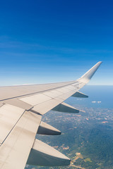 Aerial view wing of airplane from window seat.