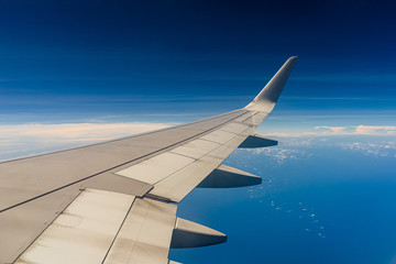 Fototapeta na wymiar Aerial view wing of airplane from window seat.