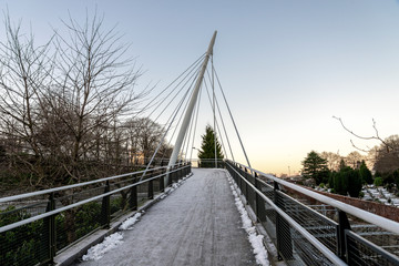 Fototapeta na wymiar A scenic pedestrian bridge next to railway tracks and Lagard cemetery in Stavanger city centre, Norway, December 2017