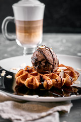 Viennese Waffles with ice cream and coffee. Beautiful picture of dessert with latte coffee. Dessert concept, sweet life. Food photo, copy space, gray background.
