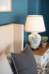 detail photo of lamp and bed with pillows