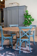 four blue chairs around a round table , dining room setup