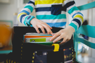 Boy packing his school bag