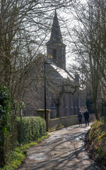 Fototapeta na wymiar Horebeke East Flanders Belgium. Church at Geuzenhoek and strollers.