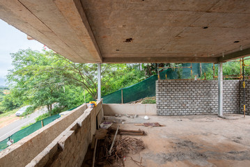 Construction site , large overhang of concrete floor with half built wall