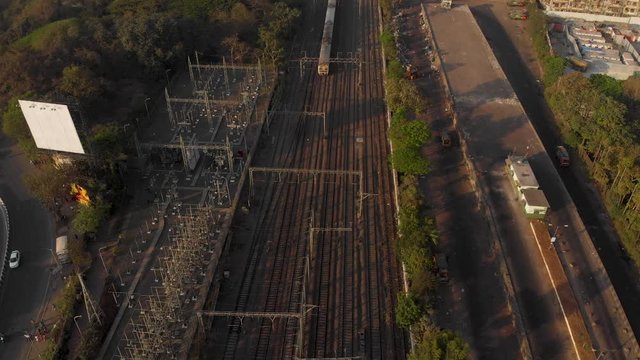 Pan up from Mumbai local train tracks to see the rest of the city